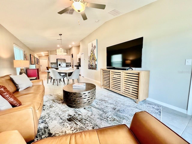 tiled living room with ceiling fan and vaulted ceiling