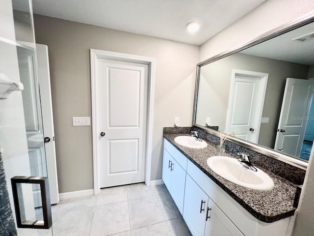 bathroom with tile patterned flooring and vanity