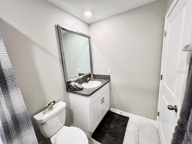 bathroom featuring vanity, toilet, a textured ceiling, walk in shower, and tile patterned flooring