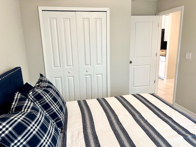 bedroom featuring a closet and light tile patterned floors