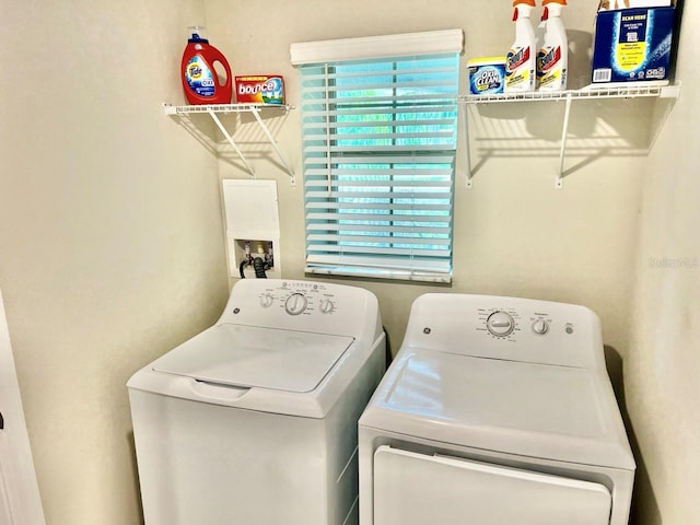 laundry area featuring separate washer and dryer and a wealth of natural light