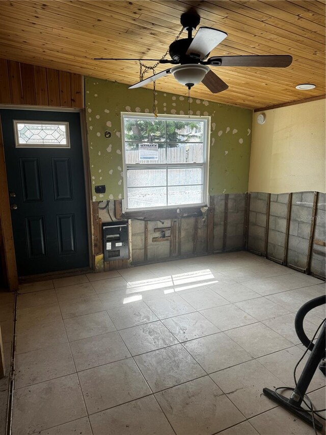 tiled entrance foyer featuring ceiling fan and wooden ceiling