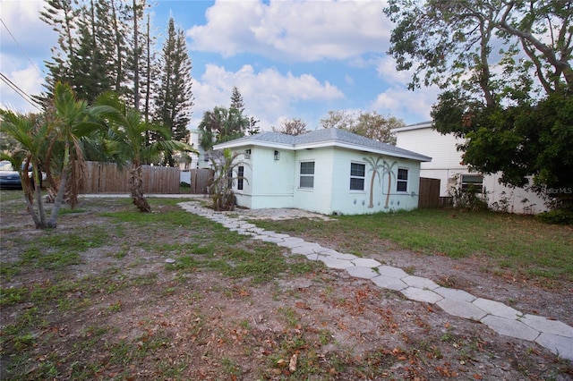 back of house featuring fence