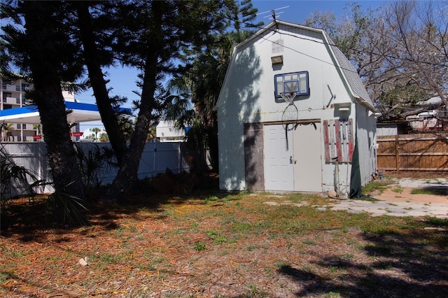 view of shed featuring fence