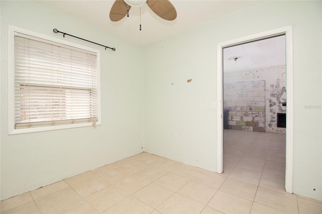 unfurnished room with light tile patterned floors and a ceiling fan