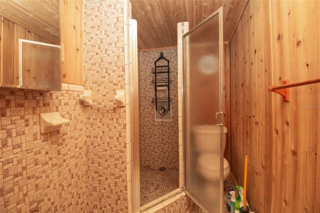 bathroom featuring toilet, a stall shower, and wood ceiling