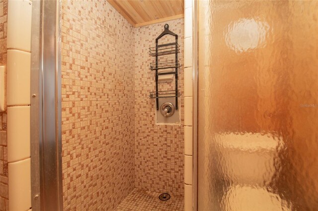 bathroom with ornamental molding and a stall shower