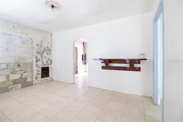 tiled living room with heating unit and arched walkways