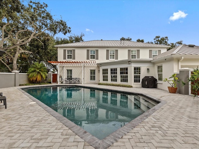 rear view of house with a patio area and a pergola