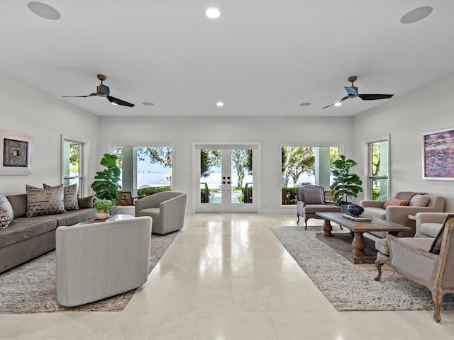 living room featuring ceiling fan, french doors, and light tile patterned floors