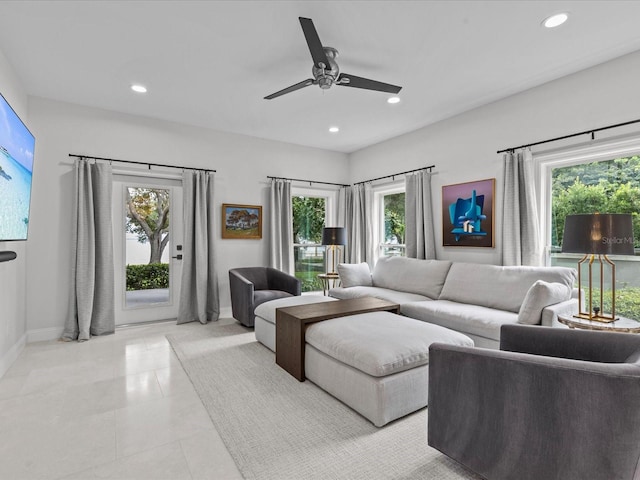 living room featuring light tile patterned flooring, a healthy amount of sunlight, and ceiling fan