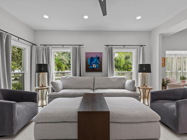 living room with light colored carpet and ceiling fan