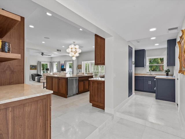 kitchen with a center island, sink, ceiling fan with notable chandelier, kitchen peninsula, and dishwasher