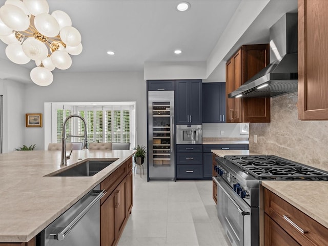 kitchen with tasteful backsplash, wall chimney exhaust hood, beverage cooler, sink, and appliances with stainless steel finishes