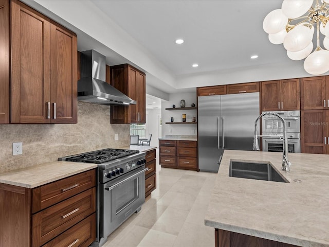 kitchen with sink, light tile patterned floors, premium appliances, wall chimney exhaust hood, and backsplash