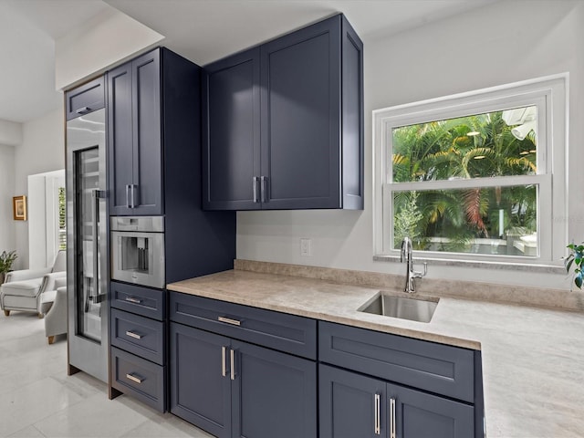 kitchen featuring light tile patterned floors, sink, and oven