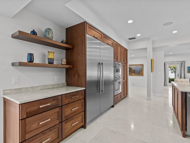 kitchen with stainless steel appliances and light tile patterned flooring