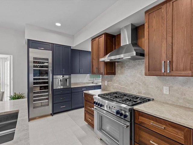 kitchen with wall chimney exhaust hood, wine cooler, sink, stainless steel appliances, and backsplash