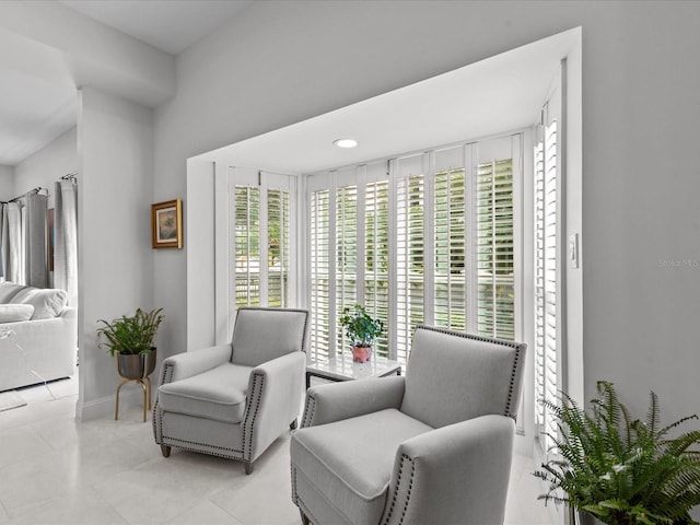 living area featuring light tile patterned flooring and a wealth of natural light