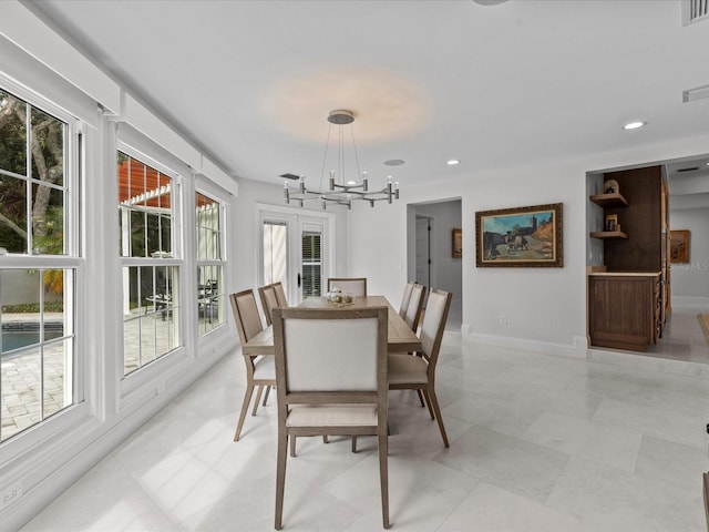 tiled dining area with an inviting chandelier