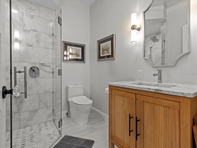 bathroom featuring a shower with door, vanity, and toilet