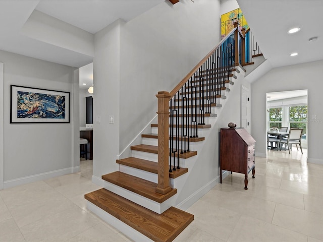 staircase featuring tile patterned flooring