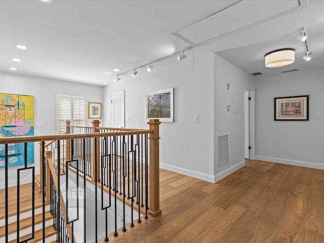 corridor with light hardwood / wood-style floors