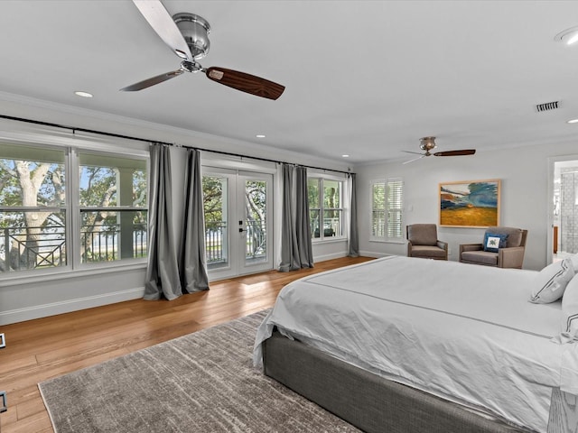 bedroom featuring ceiling fan, crown molding, light hardwood / wood-style flooring, access to outside, and french doors