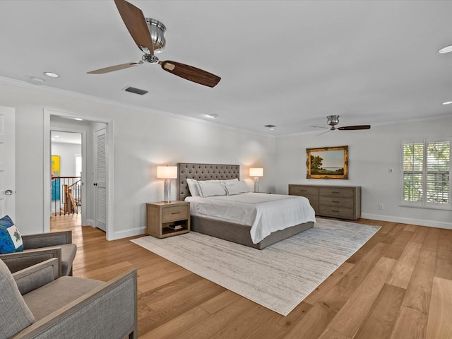 bedroom with ceiling fan, ornamental molding, and light hardwood / wood-style floors