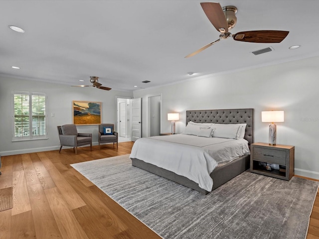 bedroom featuring wood-type flooring, crown molding, and ceiling fan