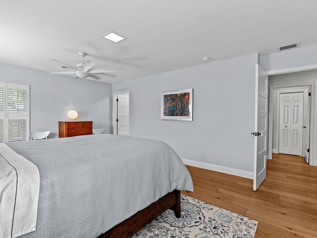 bedroom with ceiling fan and wood-type flooring