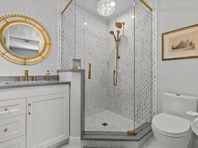 bathroom with a notable chandelier, an enclosed shower, vanity, and toilet