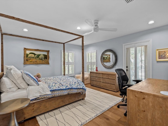 bedroom with light hardwood / wood-style floors, multiple windows, and ceiling fan