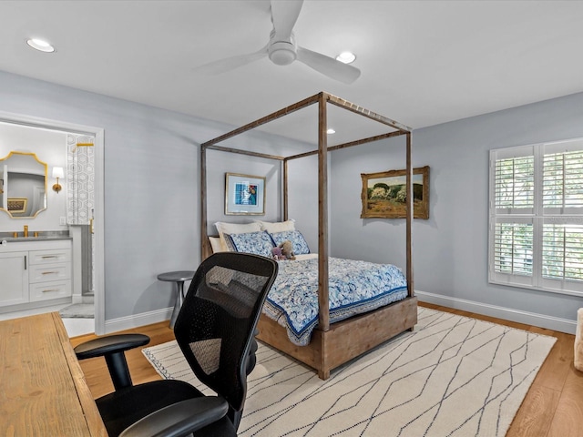 bedroom featuring light hardwood / wood-style floors, ensuite bath, and ceiling fan