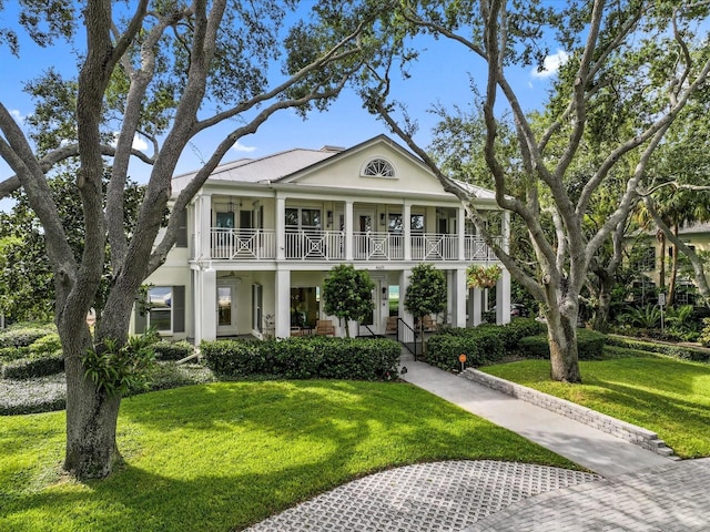 neoclassical / greek revival house with a front yard and a porch