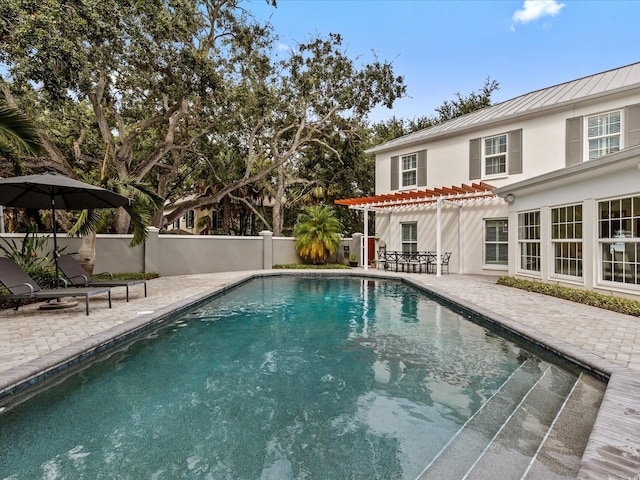 view of swimming pool featuring a pergola and a patio