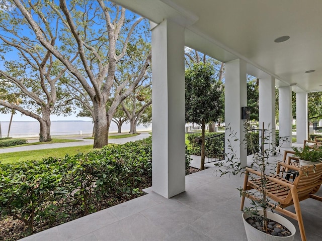 view of patio / terrace featuring a water view and a porch