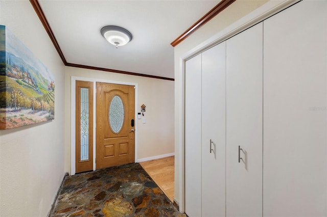 entrance foyer featuring ornamental molding and hardwood / wood-style flooring