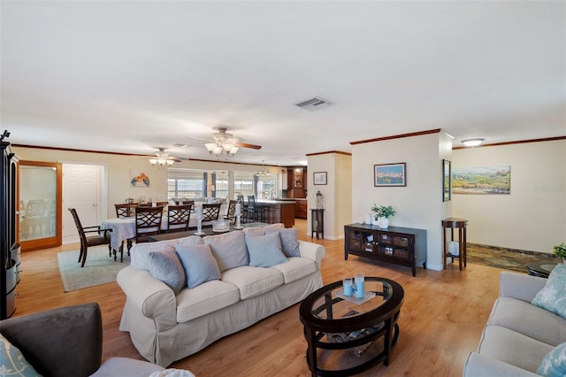 living room featuring ceiling fan, light hardwood / wood-style flooring, and ornamental molding