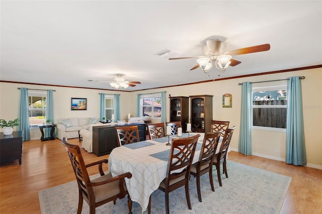 dining room featuring ornamental molding, ceiling fan, and light hardwood / wood-style flooring