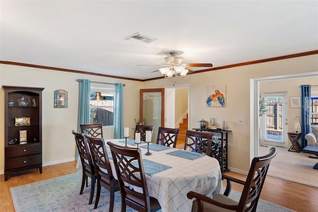 dining area with crown molding, ceiling fan, light hardwood / wood-style flooring, and plenty of natural light