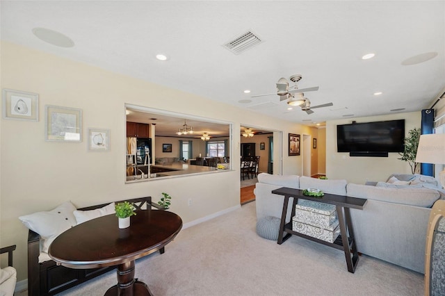 carpeted living room with ceiling fan