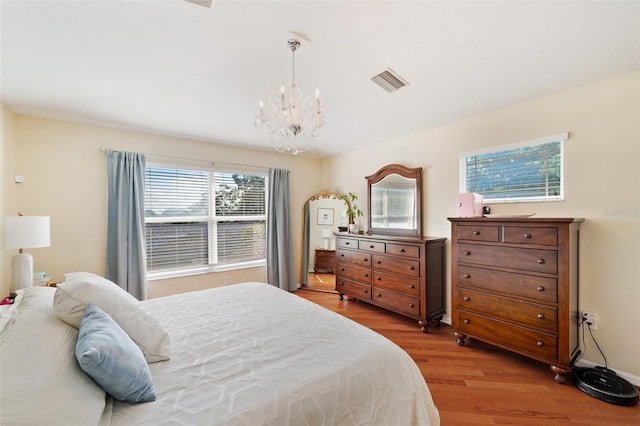 bedroom featuring a chandelier and hardwood / wood-style flooring