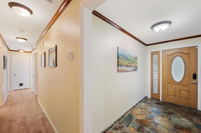 foyer entrance with crown molding and hardwood / wood-style floors