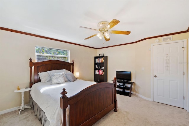 carpeted bedroom featuring ceiling fan and ornamental molding