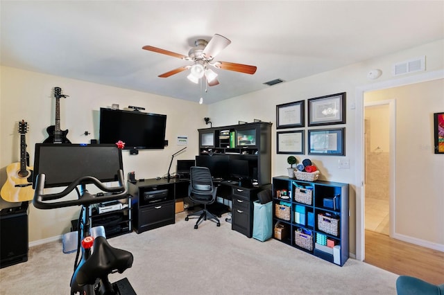 office with ceiling fan and light carpet