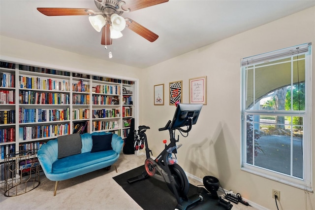 exercise room with carpet floors and ceiling fan