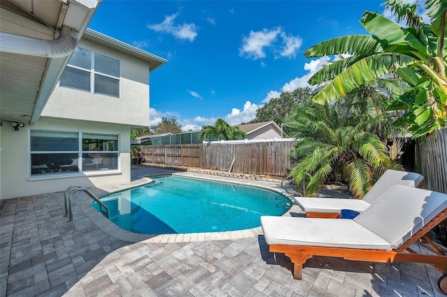 view of swimming pool with a fenced backyard, a fenced in pool, and a patio