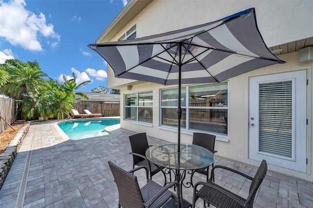 view of swimming pool with a fenced backyard, a patio area, a fenced in pool, and outdoor dining area
