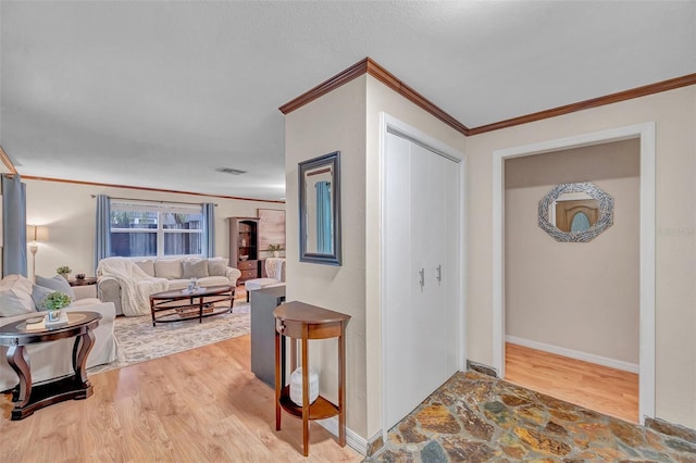 interior space with wood finished floors and crown molding